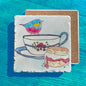 Colorful Bird on a Tea Cup Scone Tumbled Edge Stone Trivet